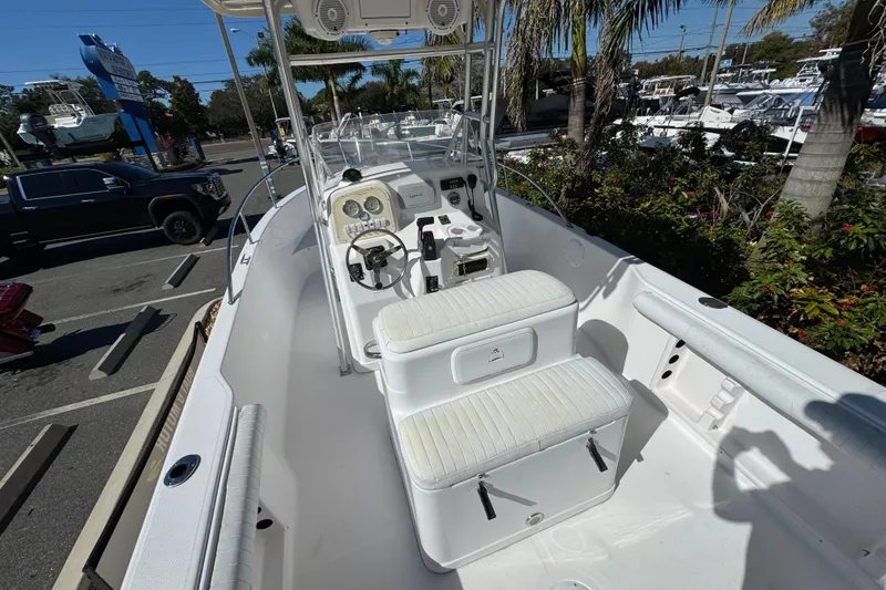 Slide: The Image of 2006 PROLINE 23 boat interior with seating and control panel, parked outdoors. - 14