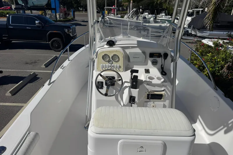 Slide: The Image of 2006 PROLINE 23 boat interior with steering console and seating in a parking lot. - 15