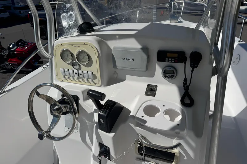 Slide: The Image of 2006 PROLINE 23 boat dashboard with Garmin GPS, steering wheel, and control panel. - 20