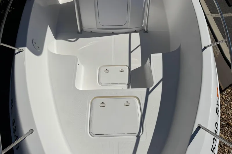 Slide: The Image of 2006 PROLINE 23 boat interior with storage compartments and clean white deck. - 27