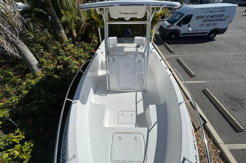 Slide: The Image of 2006 PROLINE 23 boat with T-top, parked near a van in a lot. - 29