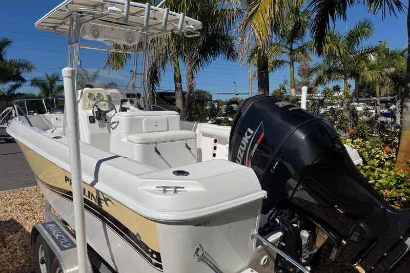 Slide: The Image of 2006 PROLINE 23 boat with Suzuki outboard motor, parked near palm trees. - 3