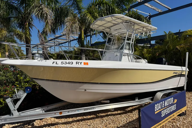 Slide: The Image of 2006 PROLINE 23 boat on trailer, displayed outdoors with palm trees. - 8