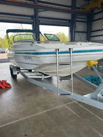 Slide: The Image of 2000 Hurricane SunDeck SD 237 OB boat on trailer in indoor storage. - 3