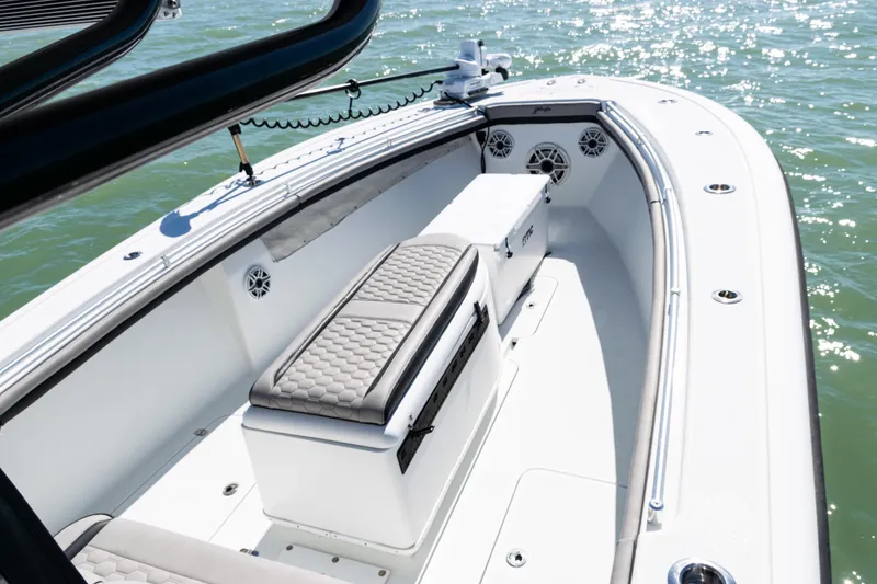 Slide: The Image of 2019 Yellowfin 36 Offshore boat interior with cushioned seating and ocean view. - 12