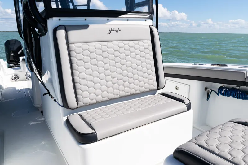 Slide: The Image of 2019 Yellowfin 36 Offshore boat with cushioned seating, on a sunny day at sea. - 17