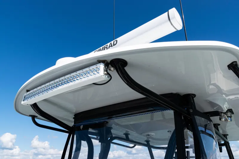 Slide: The Image of 2019 Yellowfin 36 Offshore boat with radar and LED light bar against blue sky. - 22