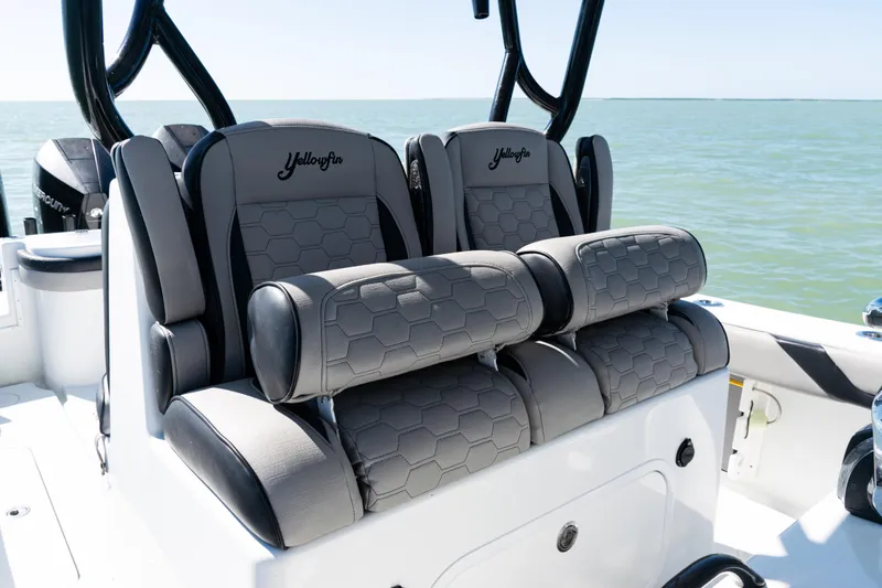 Slide: The Image of 2019 Yellowfin 36 Offshore boat seats with hexagonal pattern, on calm ocean water. - 25