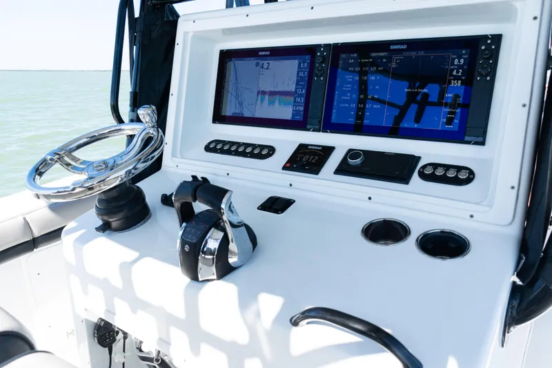Slide: The Image of 2019 Yellowfin 36 Offshore boat dashboard with dual Simrad displays and controls. - 27