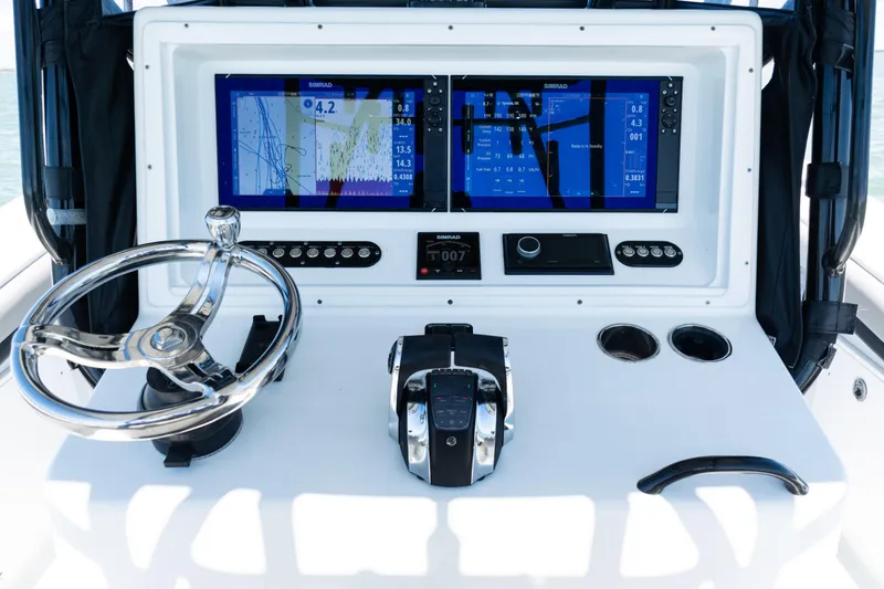 Slide: The Image of 2019 Yellowfin 36 Offshore boat dashboard with dual Simrad displays and steering wheel. - 29
