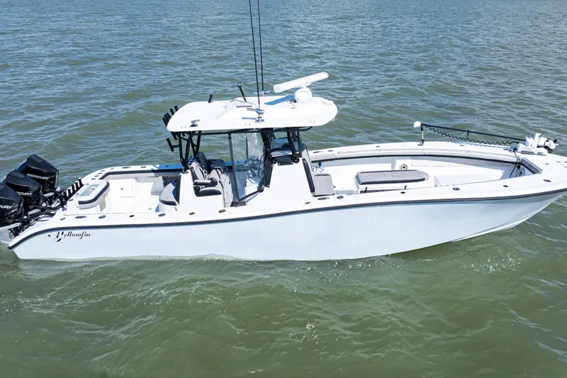Slide: The Image of 2019 Yellowfin 36 Offshore boat on water, featuring sleek design and powerful engines. - 3