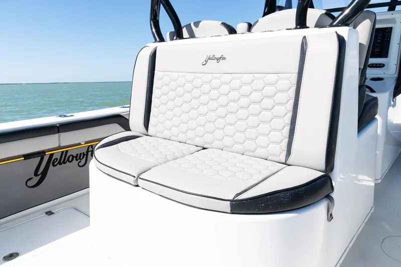 Slide: The Image of 2019 Yellowfin 36 Offshore boat with hexagonal-patterned seating, ocean backdrop. - 36