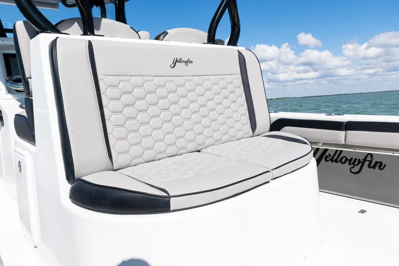Slide: The Image of 2019 Yellowfin 36 Offshore boat with hexagonal-patterned seating, ocean backdrop. - 37