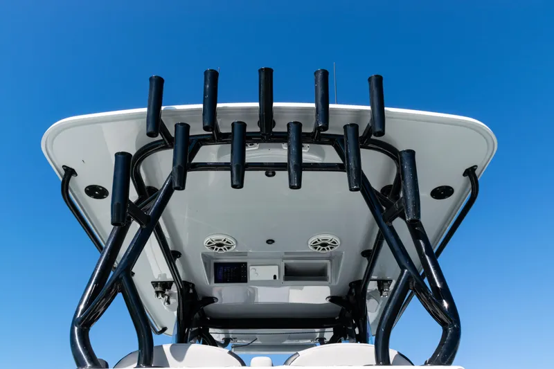Slide: The Image of 2019 Yellowfin 36 Offshore boat's T-top with rod holders against blue sky. - 38