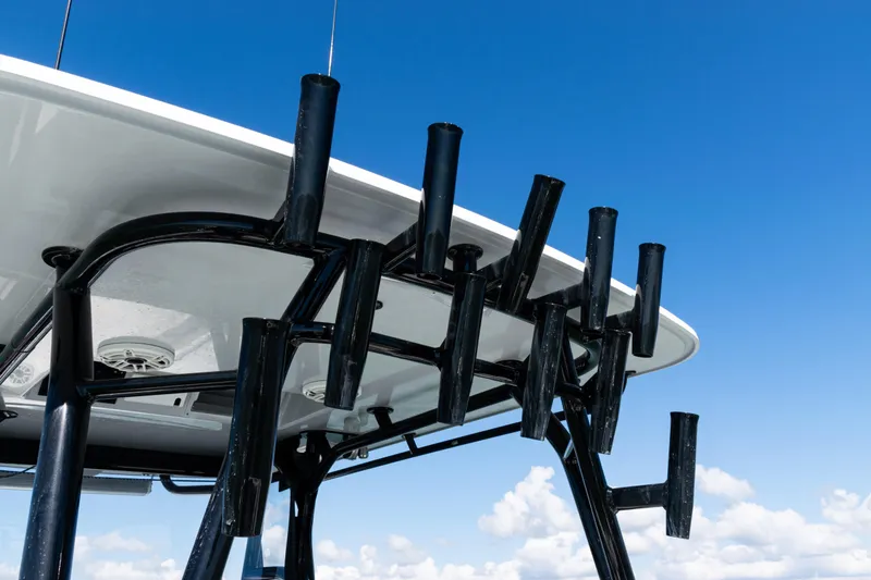 Slide: The Image of 2019 Yellowfin 36 Offshore boat with rod holders against blue sky. - 40
