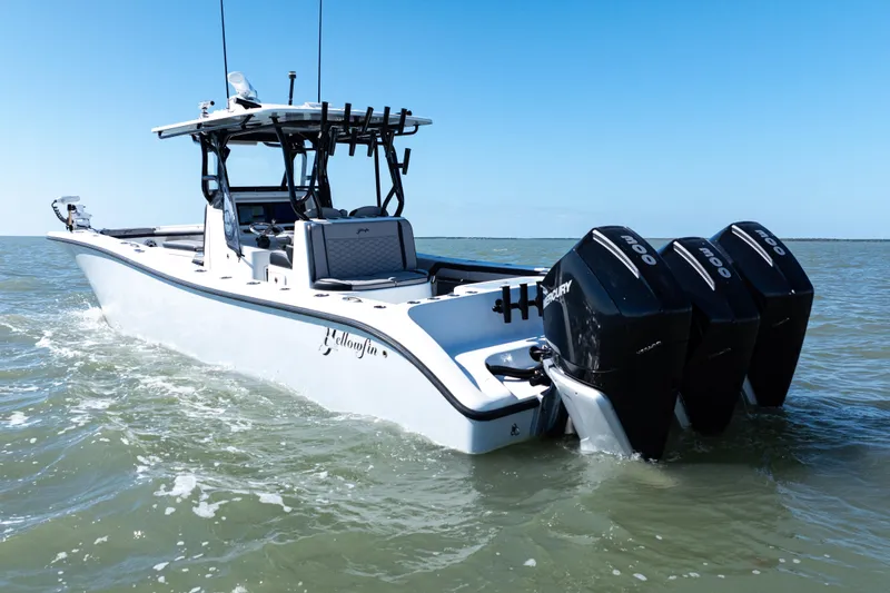 Slide: The Image of 2019 Yellowfin 36 Offshore boat with triple Mercury engines on open water. - 5