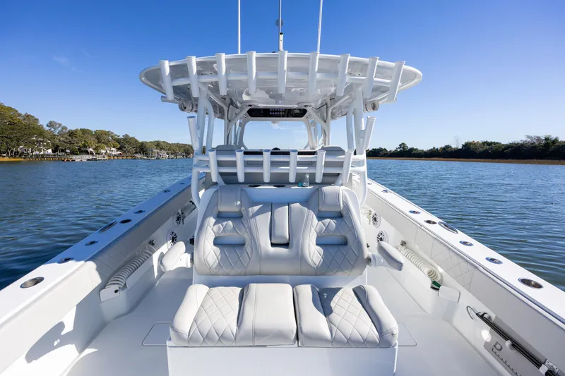 Slide: The Image of 2024 Freeman 38 boat with luxurious seating on a calm waterway. - 16