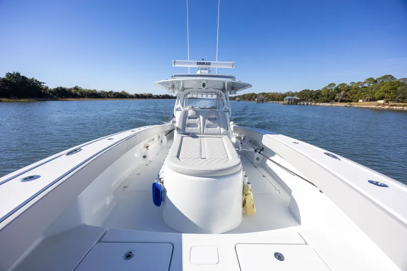 Slide: The Image of 2024 Freeman 38 boat on calm water, showcasing spacious deck and seating. - 19