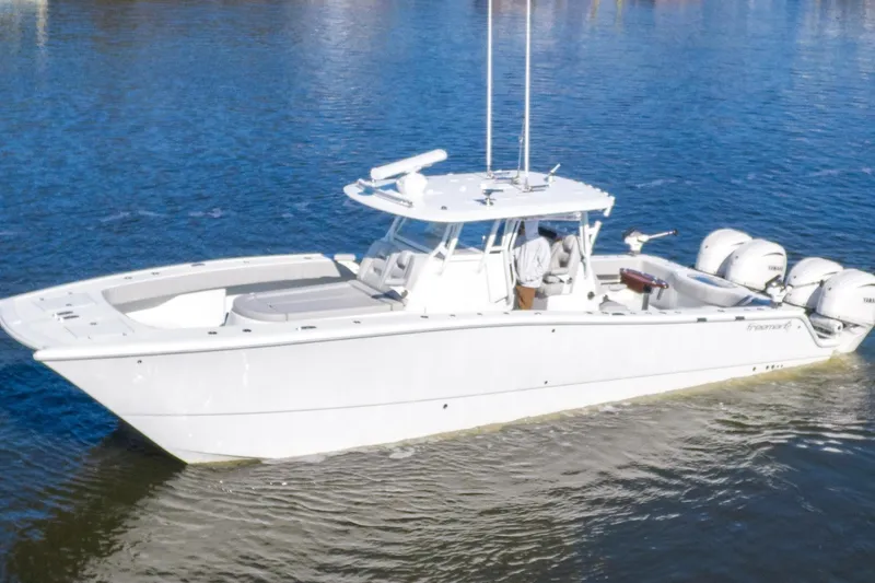 Slide: The Image of 2024 Freeman 38 boat on water, featuring sleek design and powerful engines. - 2