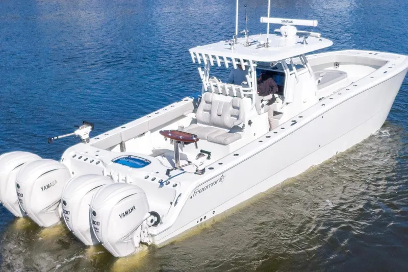 Slide: The Image of 2024 Freeman 38 boat with Yamaha engines cruising on water. - 5