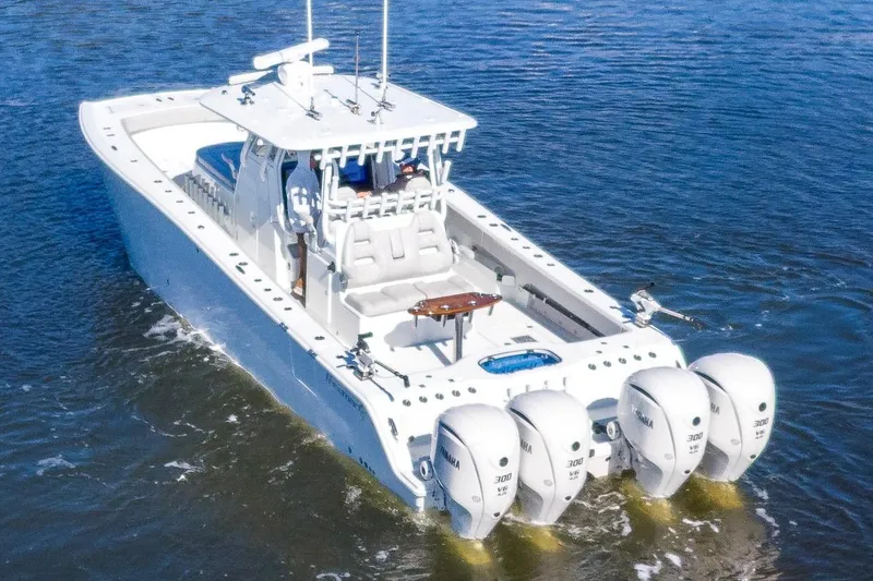 Slide: The Image of 2024 Freeman 38 boat with four outboard engines cruising on water. - 6