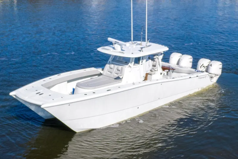 Slide: The Image of 2024 Freeman 38 boat on water, featuring sleek design and multiple outboard engines. - 7