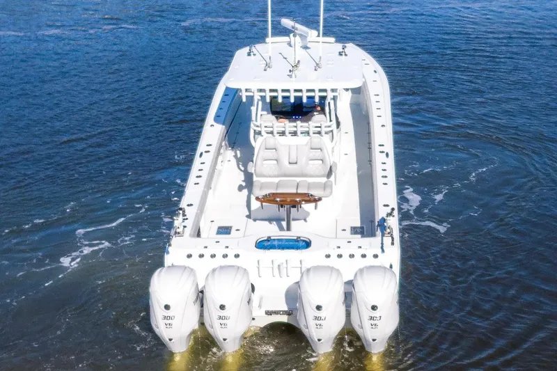 Slide: The Image of 2024 Freeman 38 boat with four powerful outboard engines on open water. - 8