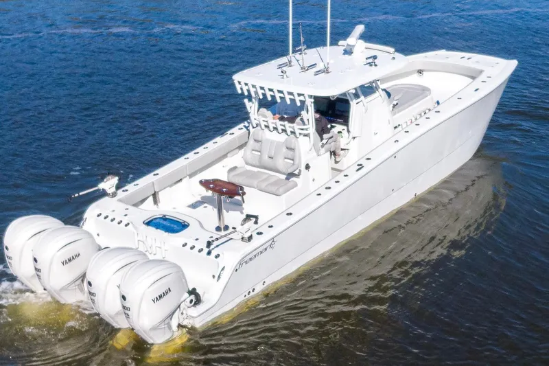 Slide: The Image of 2024 Freeman 38 boat with Yamaha engines cruising on water. - 9