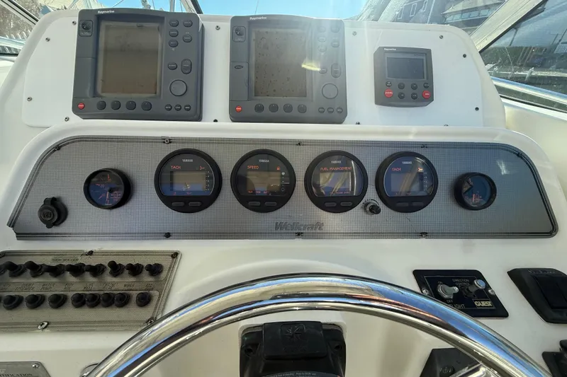 Slide: The Image of Dashboard of a 2002 Wellcraft 290 Coastal boat with navigation instruments and gauges. - 15