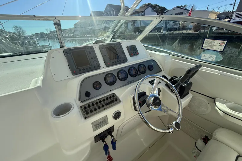 Slide: The Image of 2002 Wellcraft 290 Coastal boat helm with steering wheel and navigation instruments. - 21