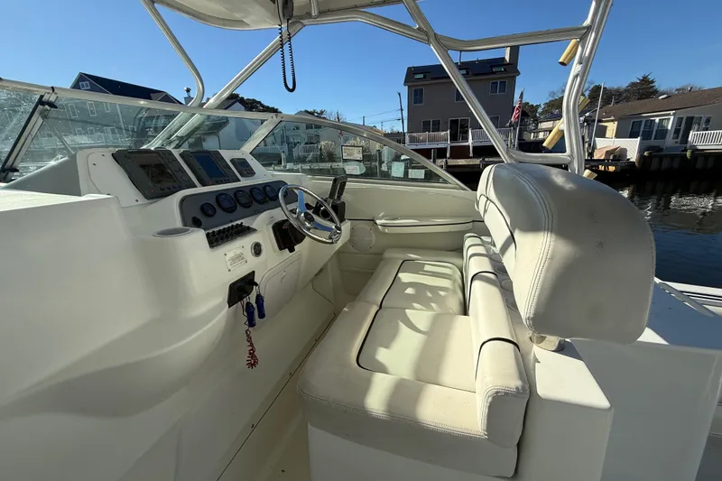 Slide: The Image of 2002 Wellcraft 290 Coastal boat interior with steering wheel and control panel. - 22