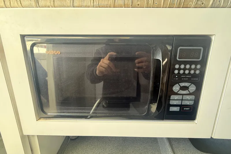 Slide: The Image of Built-in microwave in 2002 Wellcraft 290 Coastal boat interior. - 28