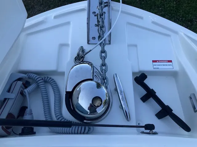 Slide: The Image of 2019 Sea Ray 310 SLX boat anchor system with chrome finish and safety warning label. - 22