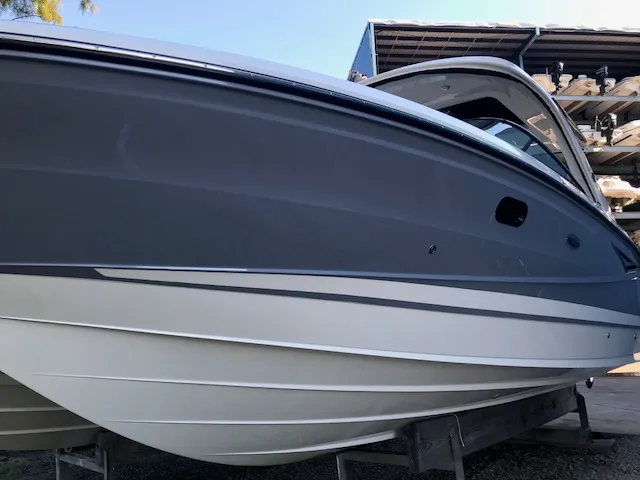 Slide: The Image of 2019 Sea Ray 310 SLX boat in storage, showcasing sleek design and modern features. - 3