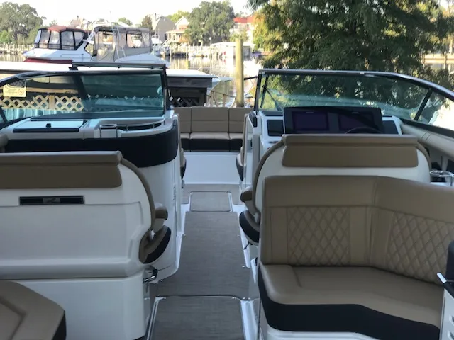 Slide: The Image of 2019 Sea Ray 310 SLX boat interior with tan seating and modern dashboard. - 9