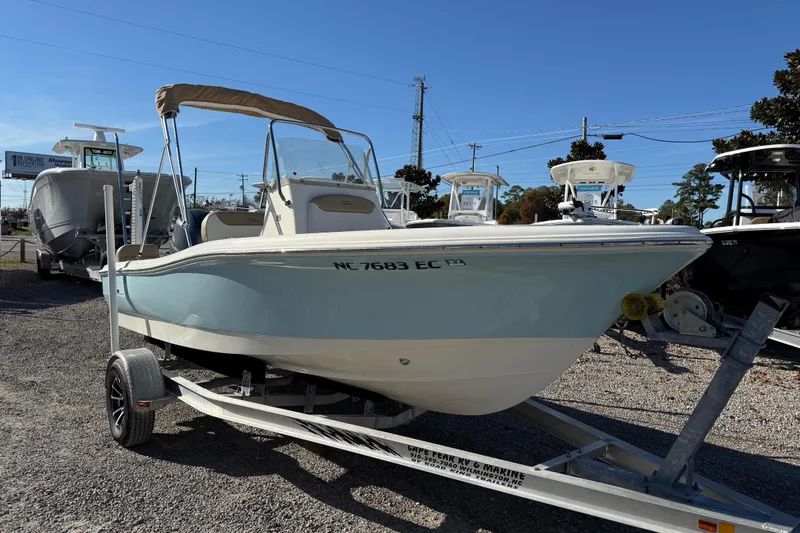 Slide: The Image of 2016 Pioneer 180 Islander boat on trailer, displayed outdoors under clear blue sky. - 1