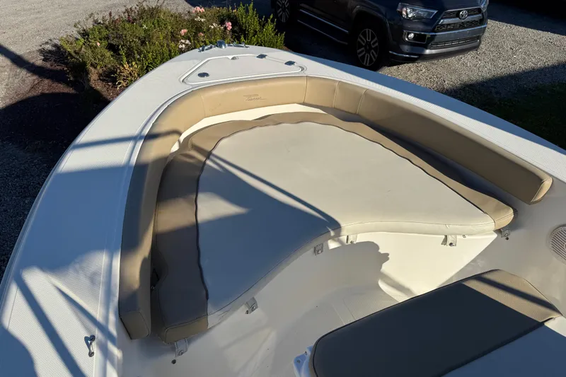 Slide: The Image of 2016 Pioneer 180 Islander boat with beige seating in sunlight. - 12