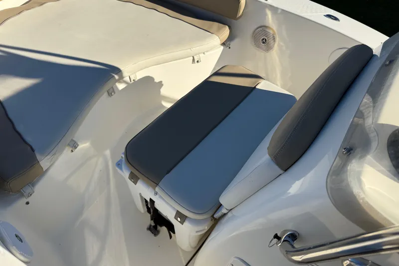 Slide: The Image of 2016 Pioneer 180 Islander boat interior with cushioned seating and storage. - 13