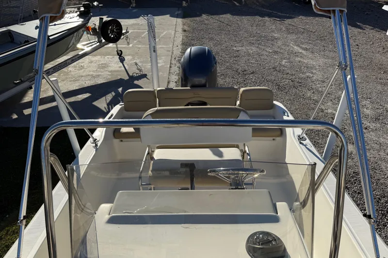 Slide: The Image of 2016 Pioneer 180 Islander boat interior with steering wheel and seating. - 14