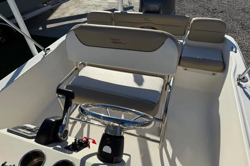 Slide: The Image of 2016 Pioneer 180 Islander boat interior with steering wheel and seating. - 15