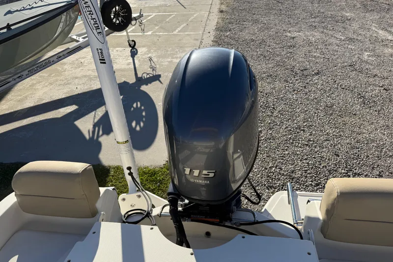 Slide: The Image of 2016 Pioneer 180 Islander boat with Yamaha 115 outboard motor, docked on gravel. - 17
