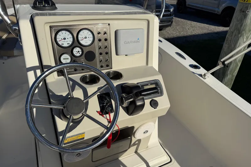 Slide: The Image of 2016 Pioneer 180 Islander boat dashboard with steering wheel and Garmin navigation system. - 18