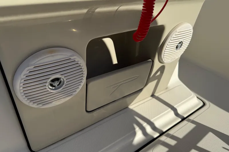 Slide: The Image of 2016 Pioneer 180 Islander boat dashboard with speakers and red safety cord. - 20