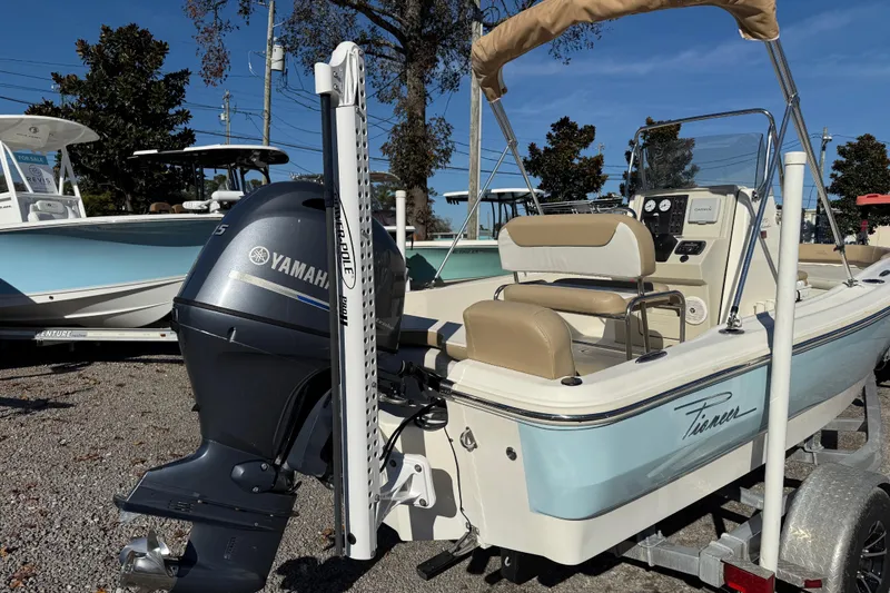 Slide: The Image of 2016 Pioneer 180 Islander boat with Yamaha motor, parked on a trailer. - 3