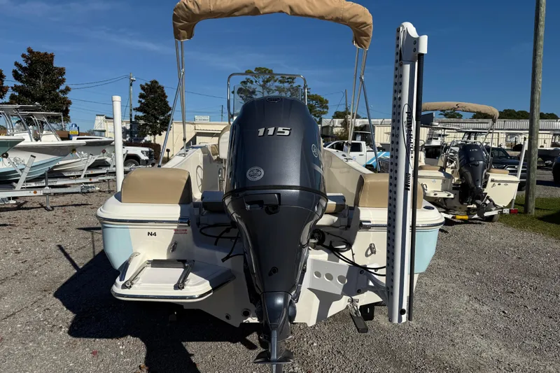 Slide: The Image of 2016 Pioneer 180 Islander boat with 115 HP outboard motor, parked outdoors. - 5