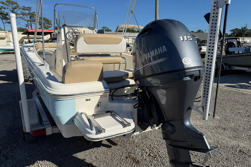 Slide: The Image of 2016 Pioneer 180 Islander boat with Yamaha 115 outboard motor, parked on a trailer. - 6