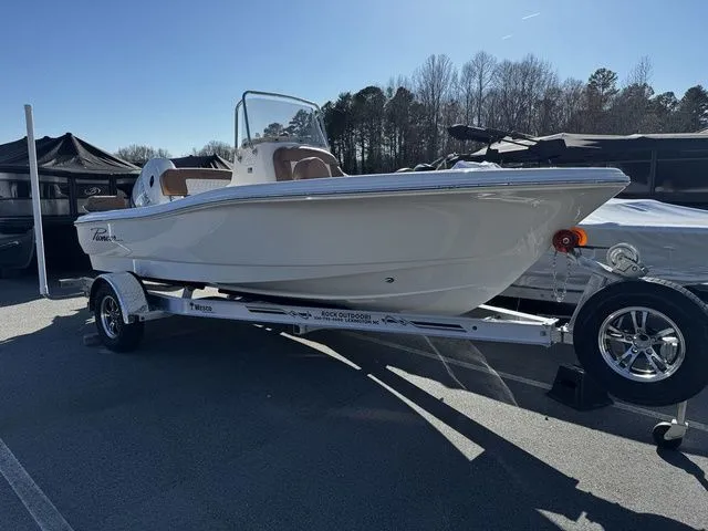 Slide: The Image of 2025 Pioneer Islander 180 boat on trailer, displayed outdoors under clear sky. - 2