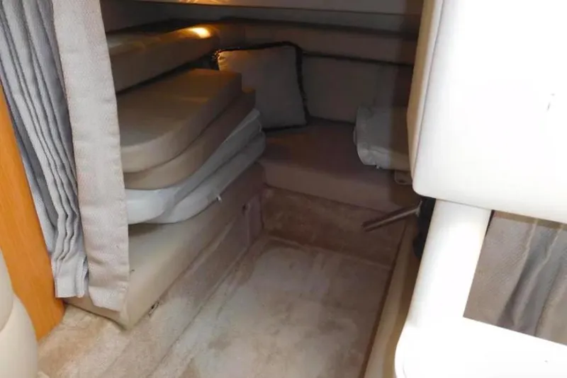 Slide: The Image of 2001 Regal Commodore 2960 cabin interior with stacked cushions and soft lighting. - 12