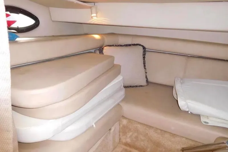 Slide: The Image of Interior cabin of 2001 Regal Commodore 2960 boat with beige seating and cushions. - 13