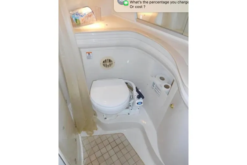 Slide: The Image of 2001 Regal Commodore 2960 boat bathroom with toilet and storage shelves. - 19